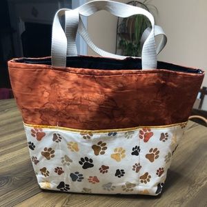 Homemade tote bag with outside pockets and covered in paw prints!